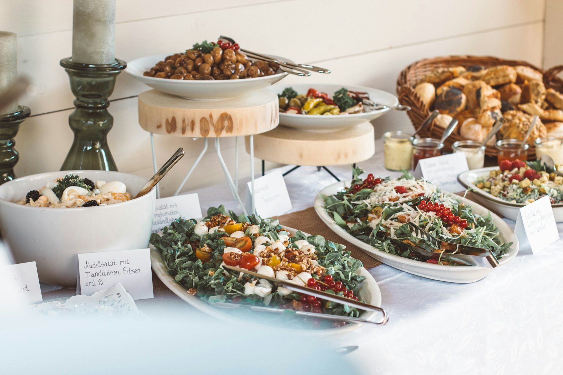 A catering spread of salads, bread and small plates