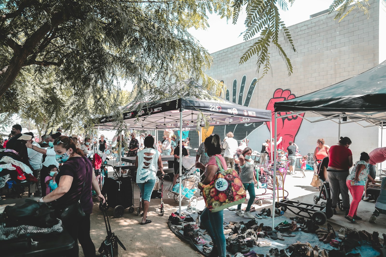 Neighbors and vendors at a community market in Watts